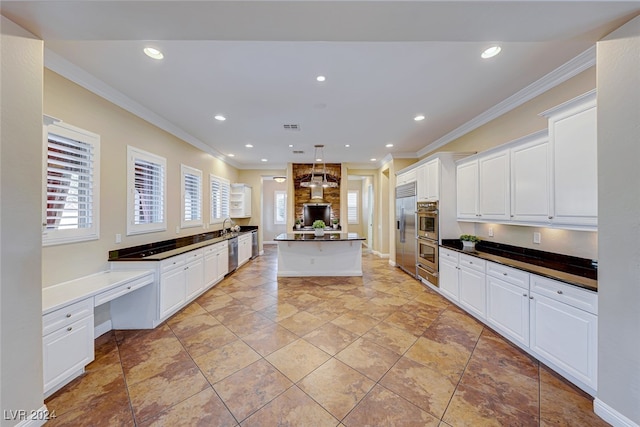 kitchen with pendant lighting, light tile patterned flooring, white cabinets, and a kitchen island with sink