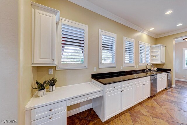 kitchen with sink, white cabinets, dishwasher, and light tile patterned floors