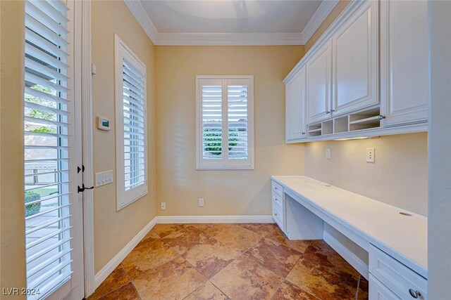 unfurnished office featuring ornamental molding and light tile patterned floors