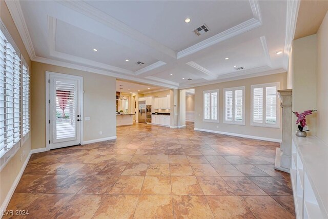 unfurnished living room featuring light tile patterned flooring, beam ceiling, coffered ceiling, and a wealth of natural light