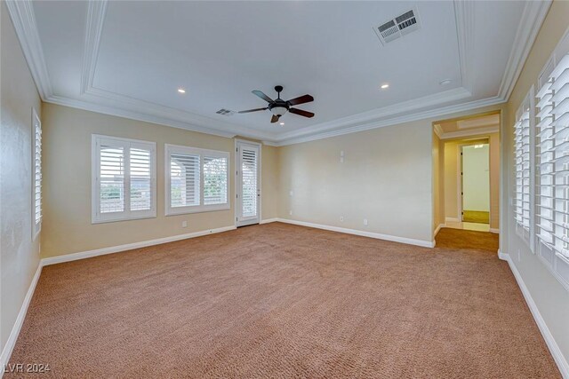 unfurnished room featuring crown molding, carpet, and ceiling fan