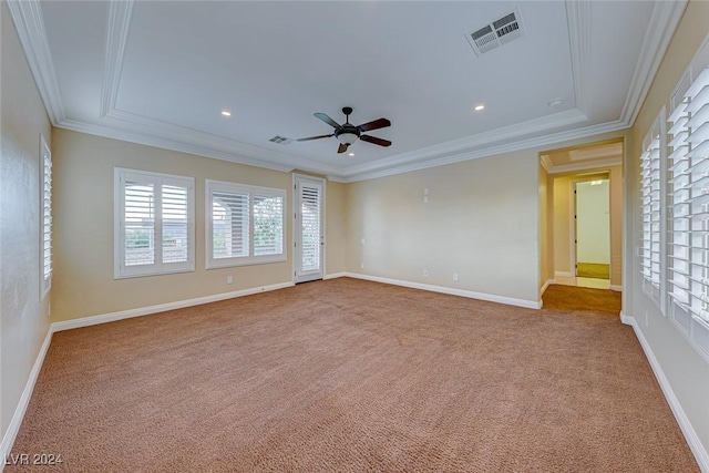 empty room featuring baseboards, carpet, visible vents, and crown molding