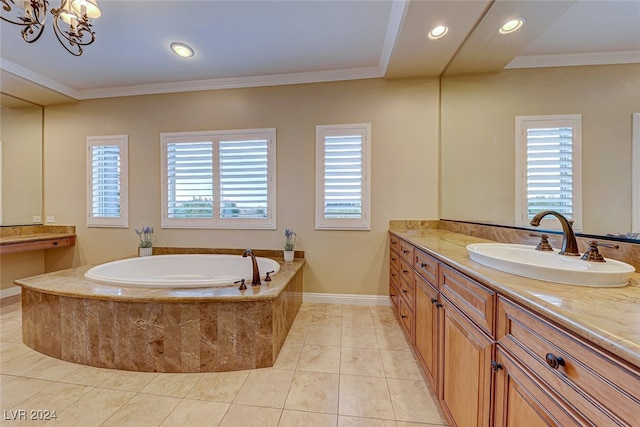 bathroom with tiled bath, tile patterned floors, a wealth of natural light, and vanity