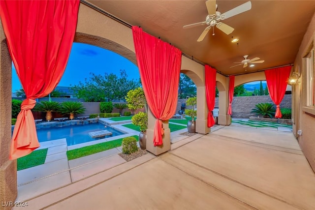 view of patio featuring ceiling fan, a fenced backyard, and a fenced in pool