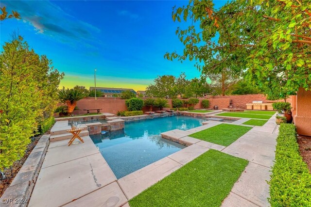 view of pool featuring an in ground hot tub and a patio