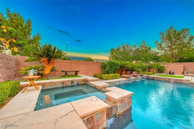 view of swimming pool with an in ground hot tub and pool water feature