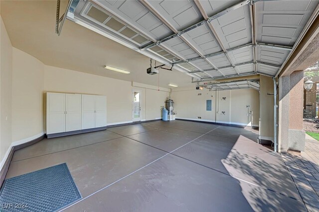 garage with a garage door opener and secured water heater