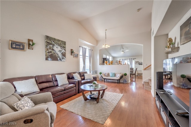 living room with high vaulted ceiling, light hardwood / wood-style flooring, ceiling fan, and a healthy amount of sunlight