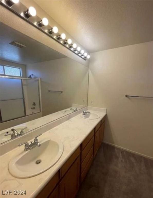 bathroom featuring bath / shower combo with glass door and vanity