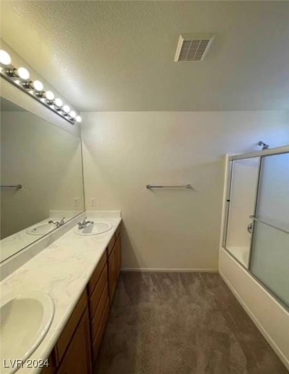 bathroom with vanity and enclosed tub / shower combo