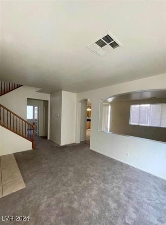 unfurnished living room featuring carpet