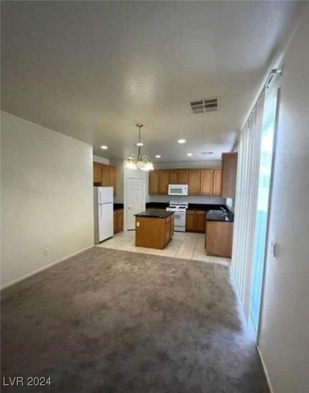 kitchen with a center island, light carpet, hanging light fixtures, a notable chandelier, and white appliances