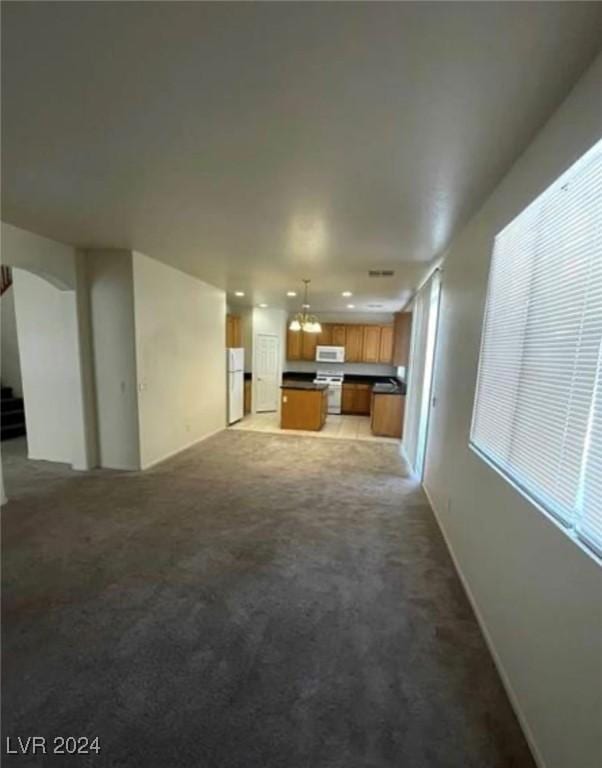 unfurnished living room featuring carpet