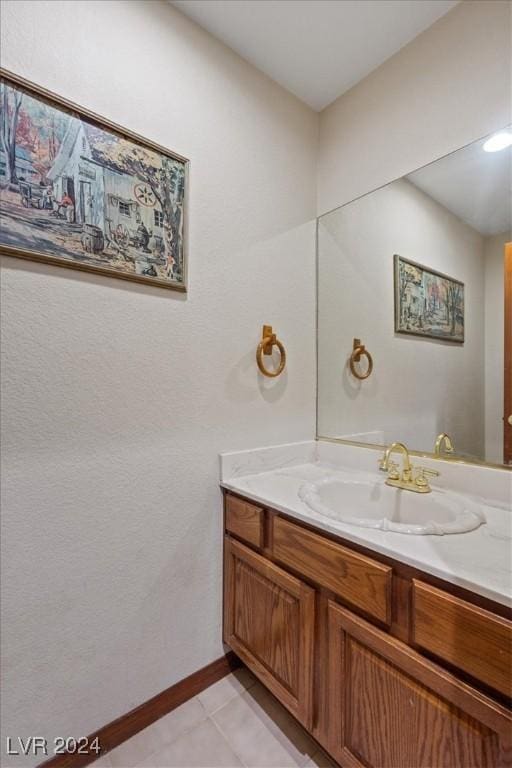 bathroom featuring tile patterned floors, baseboards, and vanity