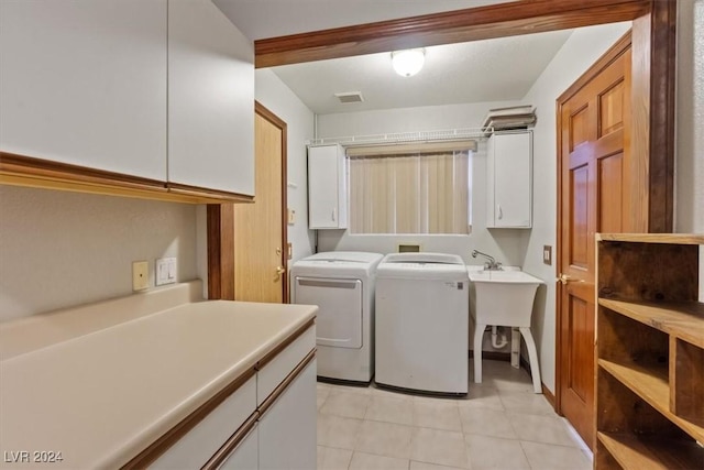 laundry area featuring light tile patterned floors, cabinet space, visible vents, and separate washer and dryer