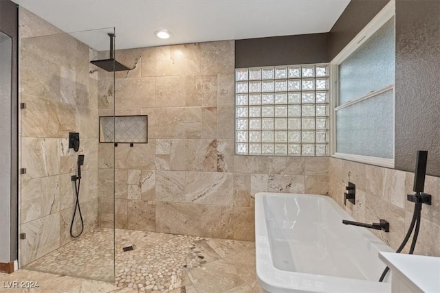 full bath featuring recessed lighting, a walk in shower, and a bathing tub