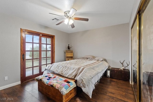 bedroom featuring baseboards, visible vents, a ceiling fan, wood finished floors, and a closet