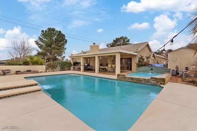 view of swimming pool with a fenced in pool, a patio area, and an in ground hot tub