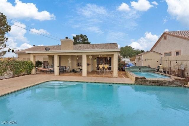 view of pool with an in ground hot tub, fence, a fenced in pool, and a patio