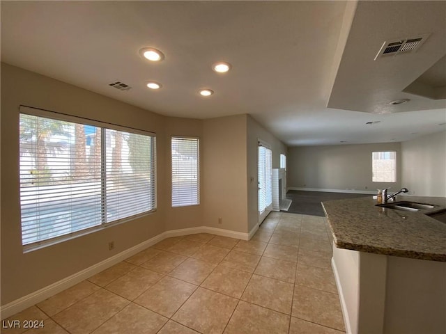 kitchen featuring a sink, visible vents, and baseboards