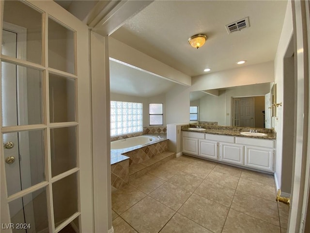 full bathroom with a sink, visible vents, tile patterned flooring, and a garden tub