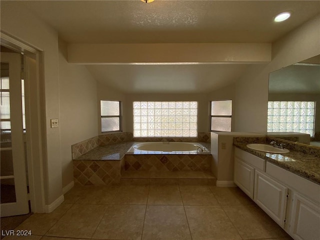 bathroom with vanity, a bath, lofted ceiling, and tile patterned flooring