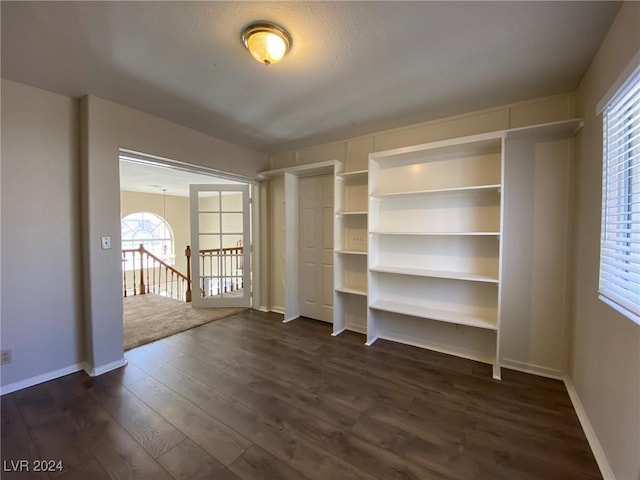 interior space with dark wood finished floors and baseboards