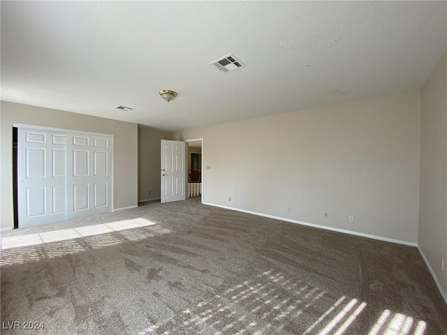 unfurnished bedroom featuring visible vents, baseboards, and carpet