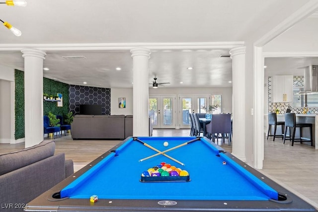 rec room with french doors, ceiling fan, ornate columns, and wood finished floors