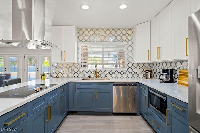 kitchen featuring stainless steel appliances, extractor fan, a sink, and light countertops