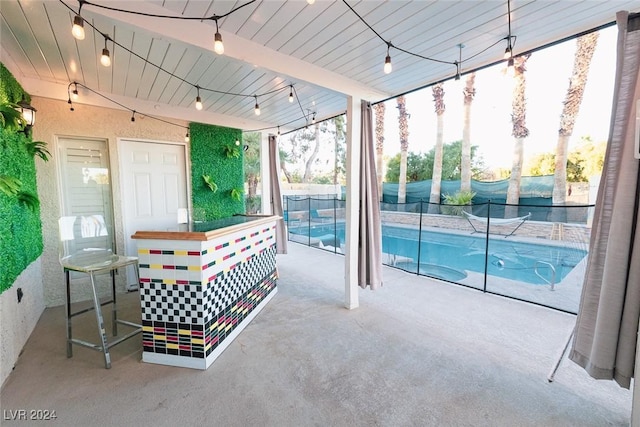 view of swimming pool with a patio area, a fenced in pool, fence, and an outdoor bar