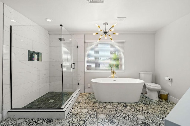 bathroom featuring an inviting chandelier, a stall shower, a freestanding tub, baseboards, and tile patterned floors