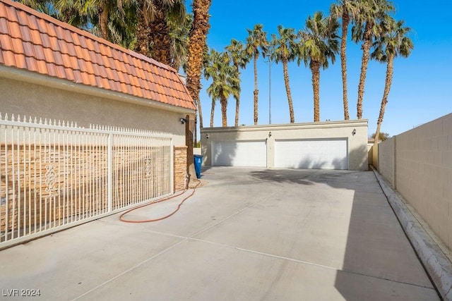 detached garage featuring fence