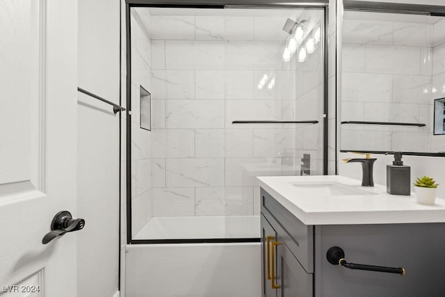 full bath featuring combined bath / shower with glass door and vanity