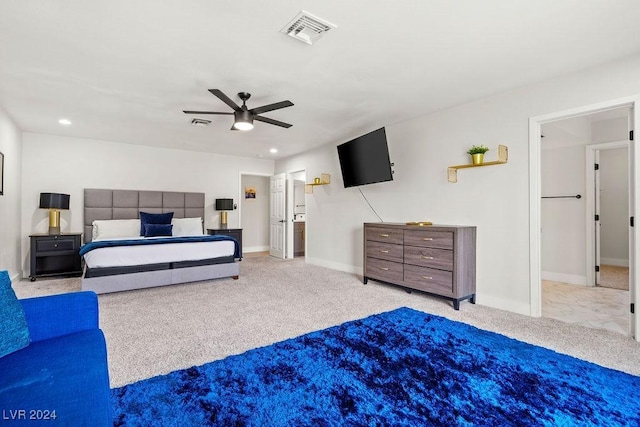 bedroom with baseboards, visible vents, and light colored carpet