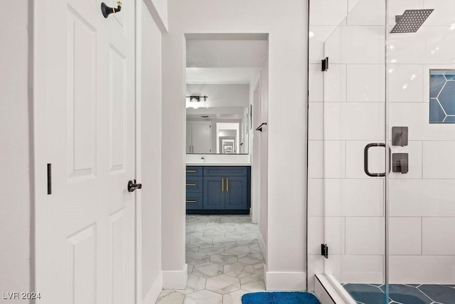 full bathroom with a stall shower, vanity, and baseboards