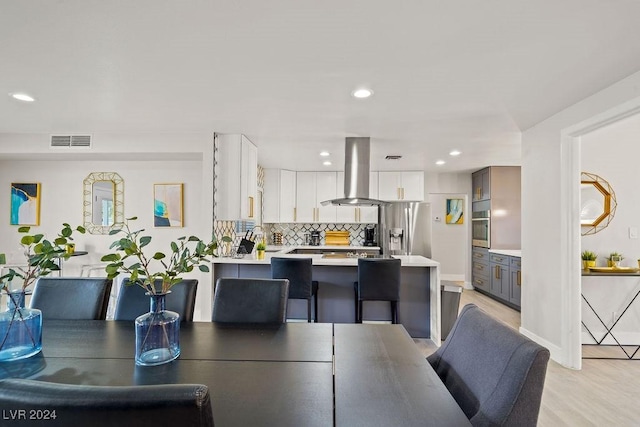 dining area with recessed lighting, visible vents, and light wood-style flooring