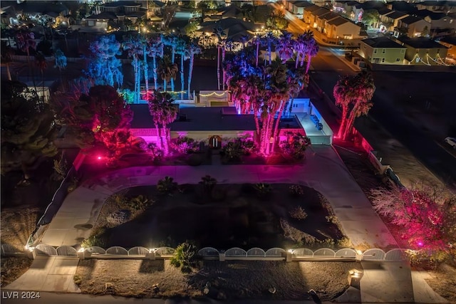 yard at night featuring a residential view