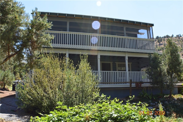 rear view of property featuring a balcony