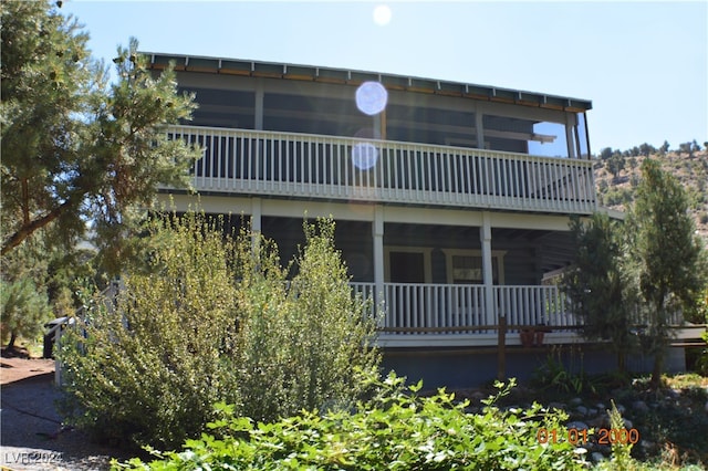 back of house with a balcony