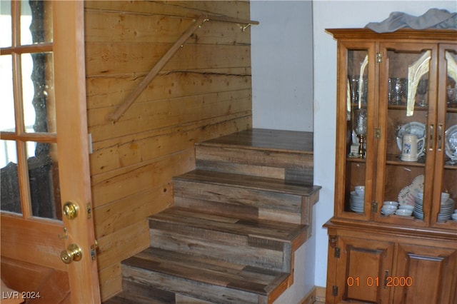 staircase with wooden walls