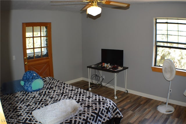 bedroom featuring multiple windows, wood-type flooring, and ceiling fan