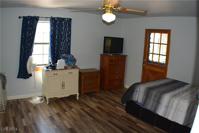 bedroom with dark hardwood / wood-style flooring and ceiling fan