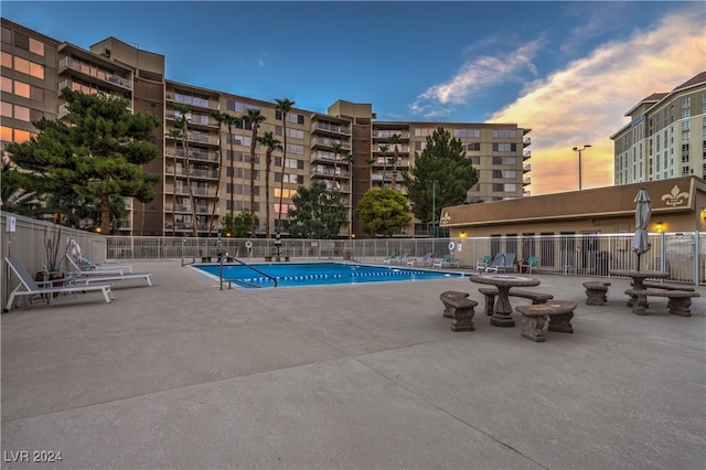 view of pool at dusk