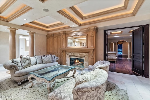 living room featuring a fireplace, dark hardwood / wood-style flooring, ornate columns, coffered ceiling, and ornamental molding