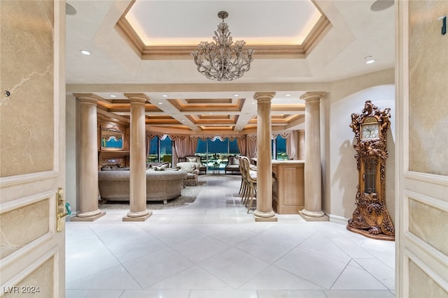 hallway with a notable chandelier, coffered ceiling, decorative columns, and tile patterned floors