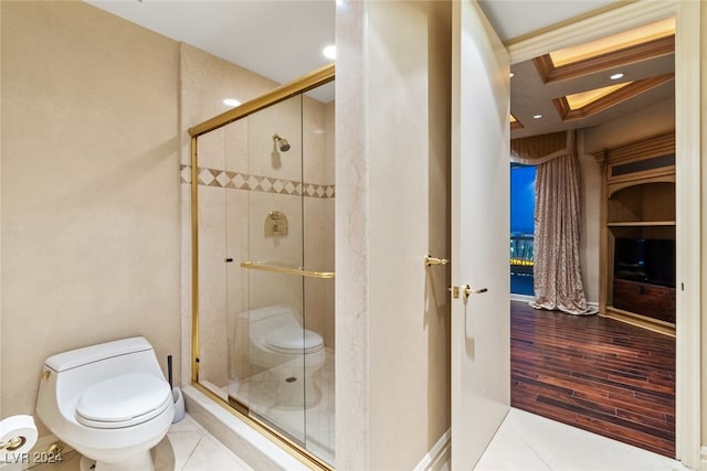 bathroom with toilet, hardwood / wood-style flooring, and a shower with door