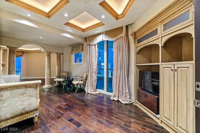 living room with crown molding, dark hardwood / wood-style flooring, and ornate columns