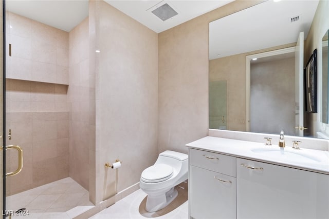 bathroom with a shower with door, vanity, and toilet