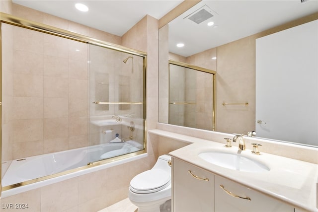 full bathroom with vanity, toilet, and combined bath / shower with glass door